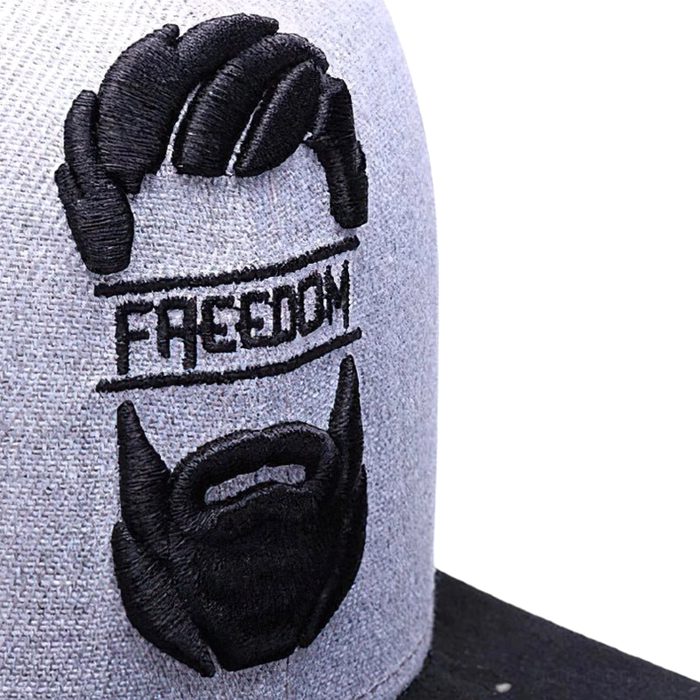 Extreme close-up of 3D embroidered mustache and beard design on gothic cap showing dimensional stitching and detail
