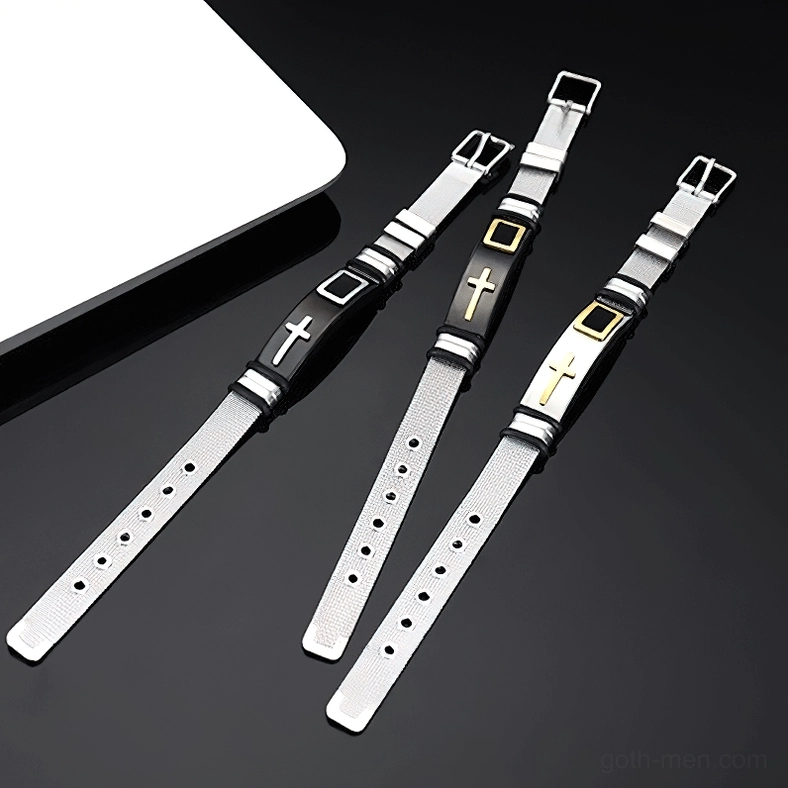 Three adjustable cross stainless steel bracelets with buckle closure shown in flat lay on white background with laptop prop for scale