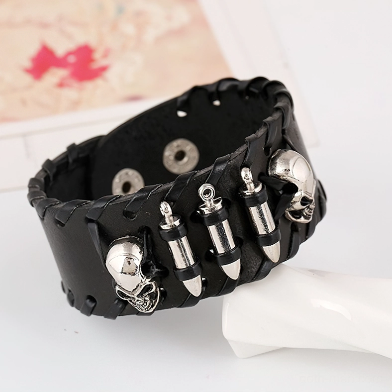 Black braided leather gothic bracelet with skull and bullet metal ornaments, side oblique view showing texture and craftsmanship