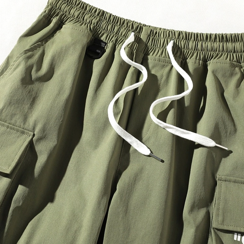 Detailed view of army green gothic shorts elastic waist and drawstring mechanism