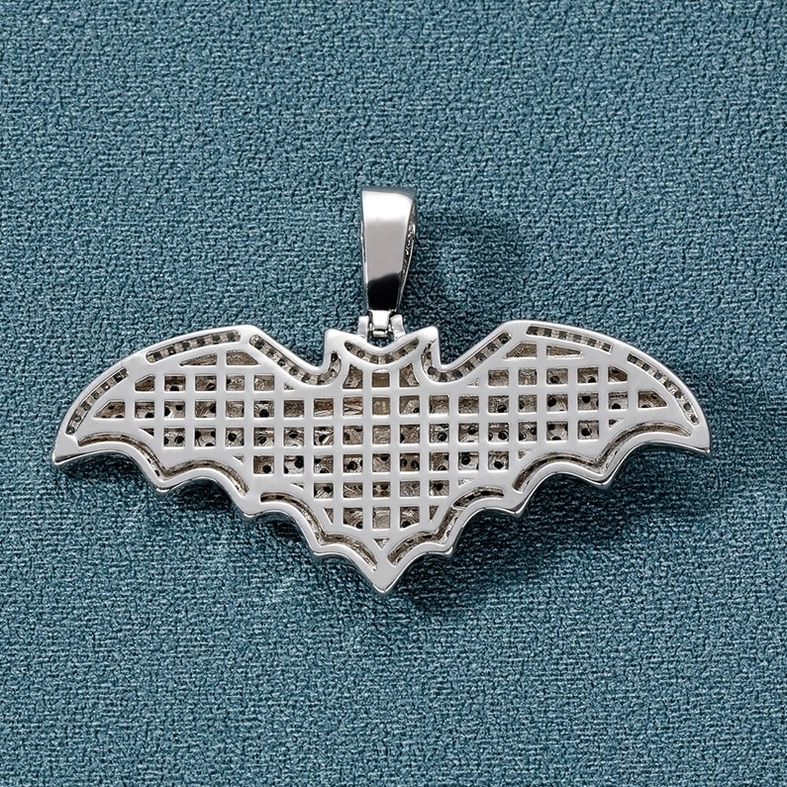 Reverse side of gothic bat pendant showing hollow grid back design and polished silver metal finish