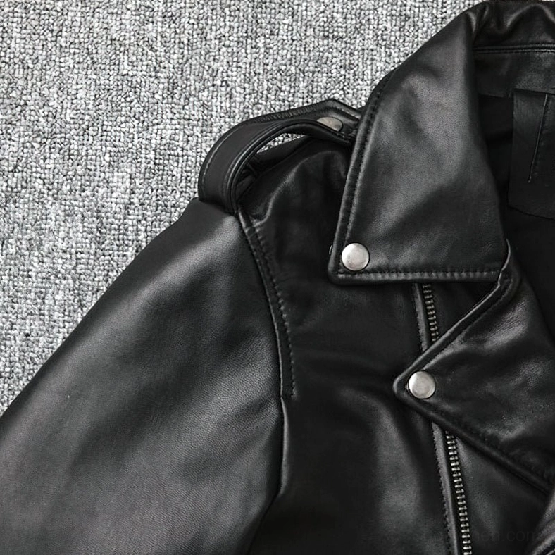 Black leather biker jacket shoulder detail close-up snap epaulets natural grain metal accents