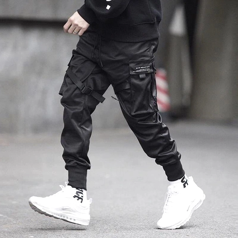 Black cargo pants with matte fabric and strap details - side full body view