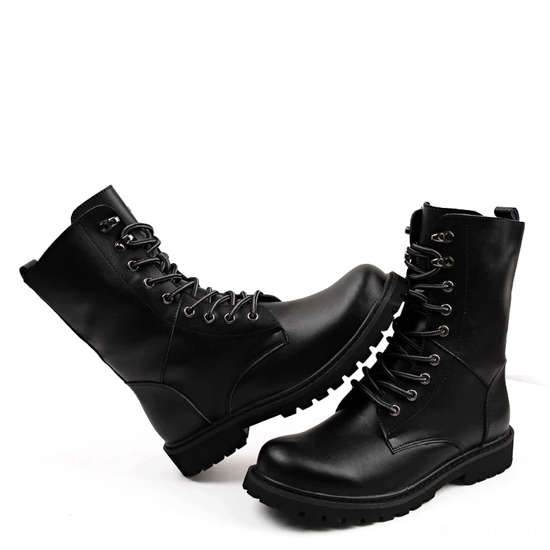 Black high-top combat boots with full lace-up design displayed in crossed position, showcasing matte leather finish and aggressive rubber sole