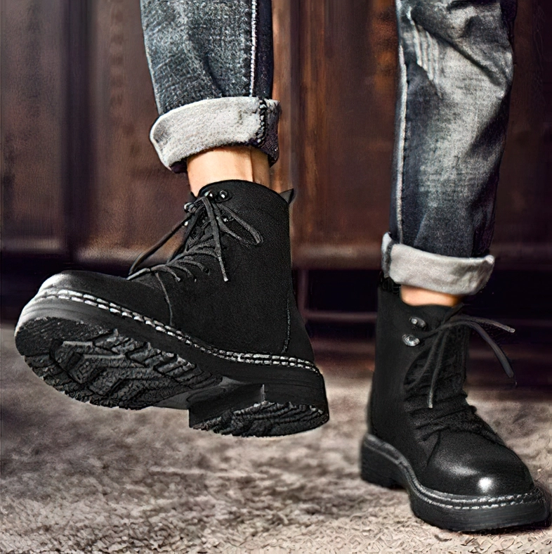 Black leather combat boots with protective rubber sole and industrial-grade construction