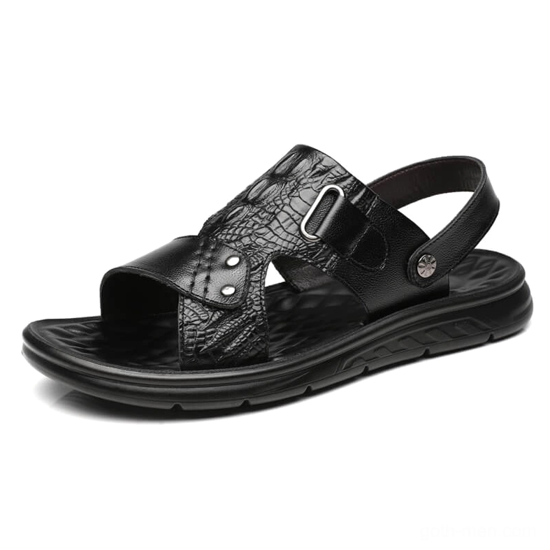 Black crocodile embossed leather sandals with adjustable buckle strap, three-quarter side view showcasing reptilian texture and gothic aesthetic