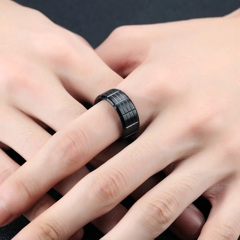 Black gothic grid ring worn on middle finger side view showcasing polished finish