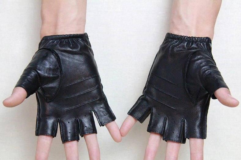 Male model wearing black fitted half-finger sheepskin leather gloves, front view showcasing fingerless gothic design