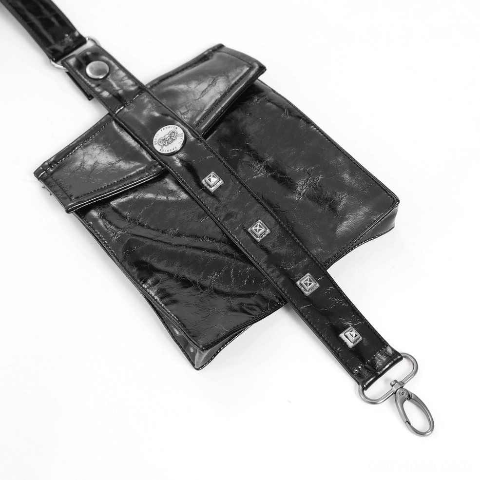 Black glossy faux leather gothic harness close-up flat lay showing metal buckles and rivet decorations