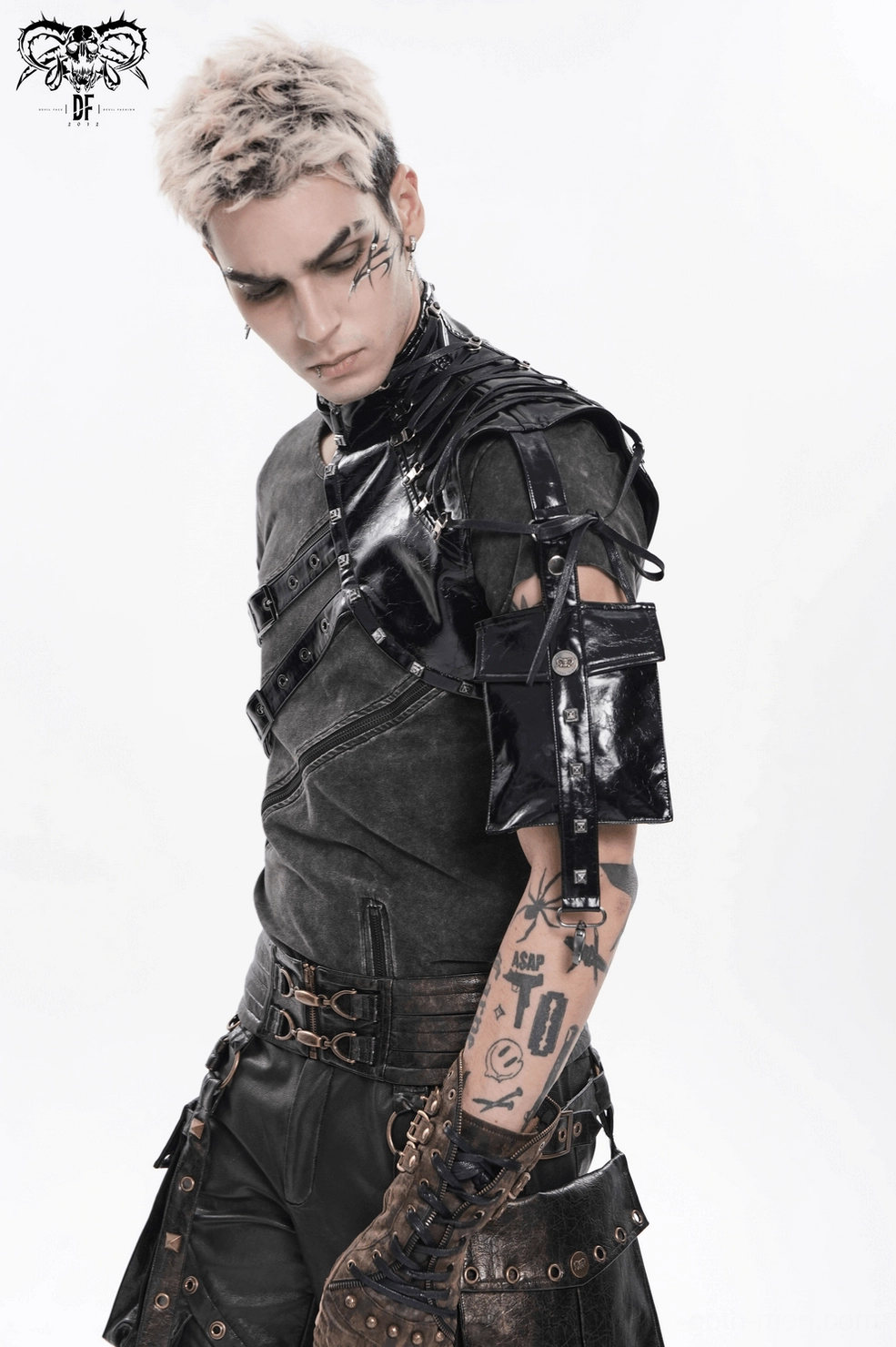 Black gothic harness vest detail showing metal rivets and synthetic leather texture