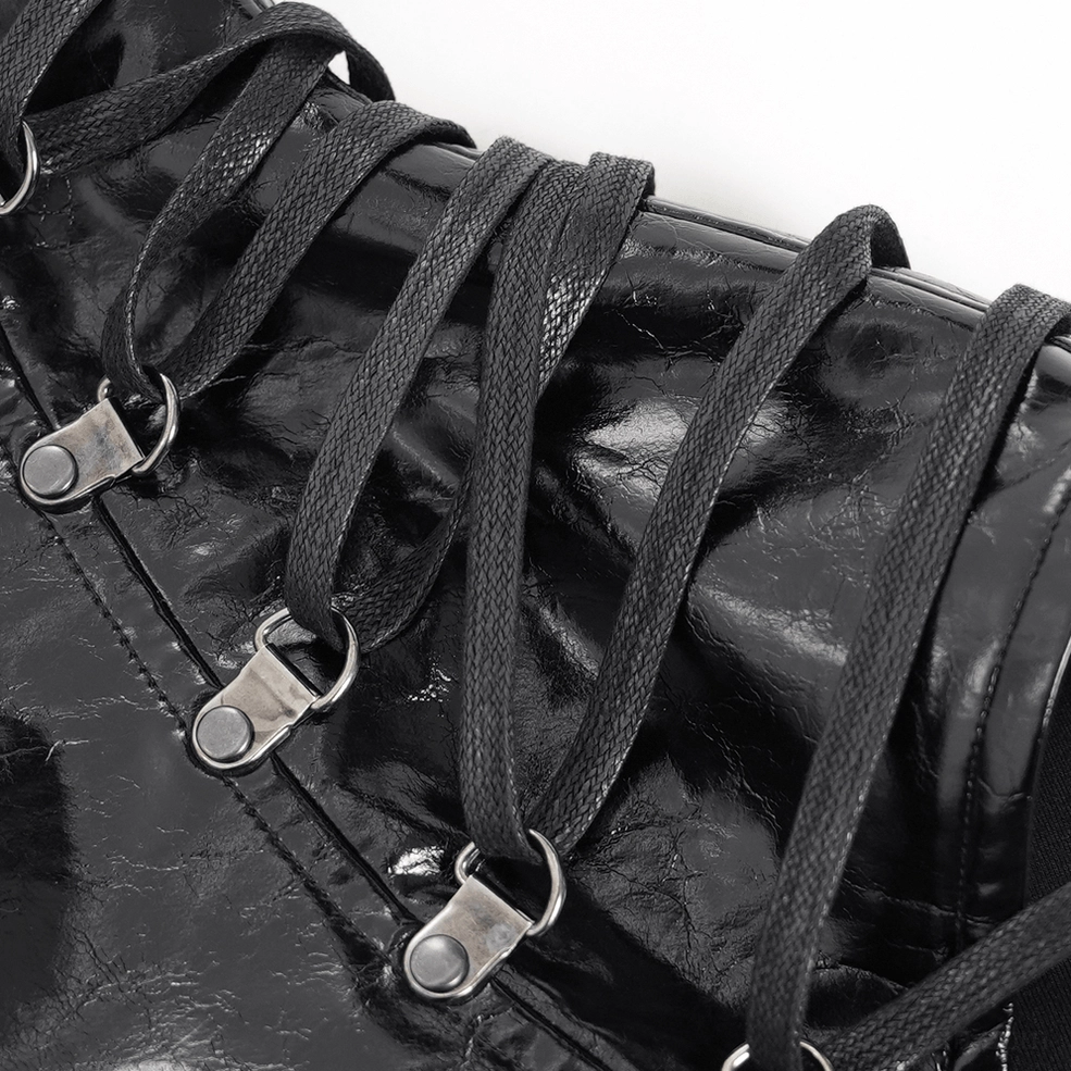 Black gothic shoulder harness vest showing studded panels and industrial hardware accents