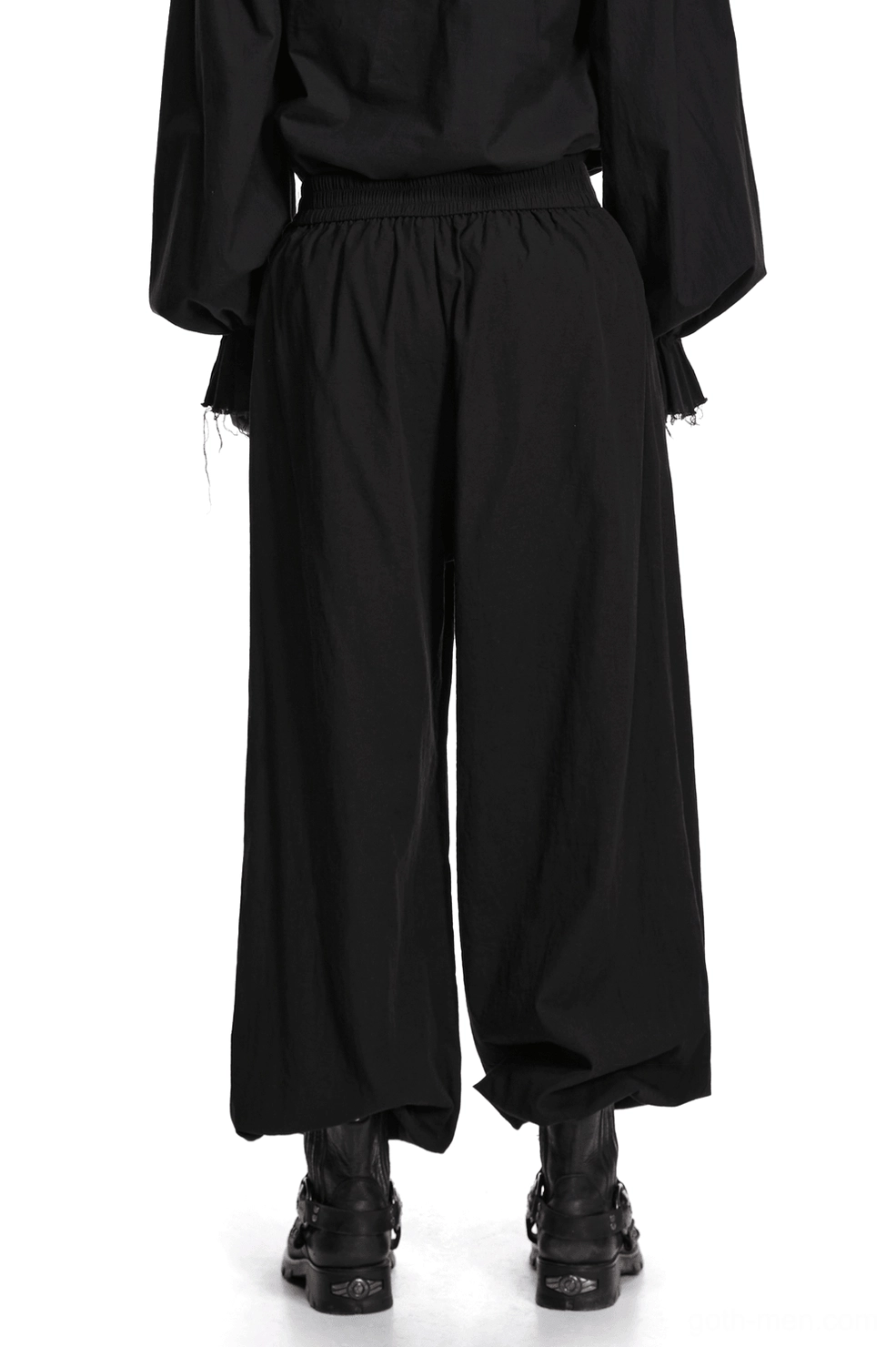 Black gothic pleated lantern tapered pants back view on male model, displaying elastic waistband and graceful drape of gathered ankle cuffs
