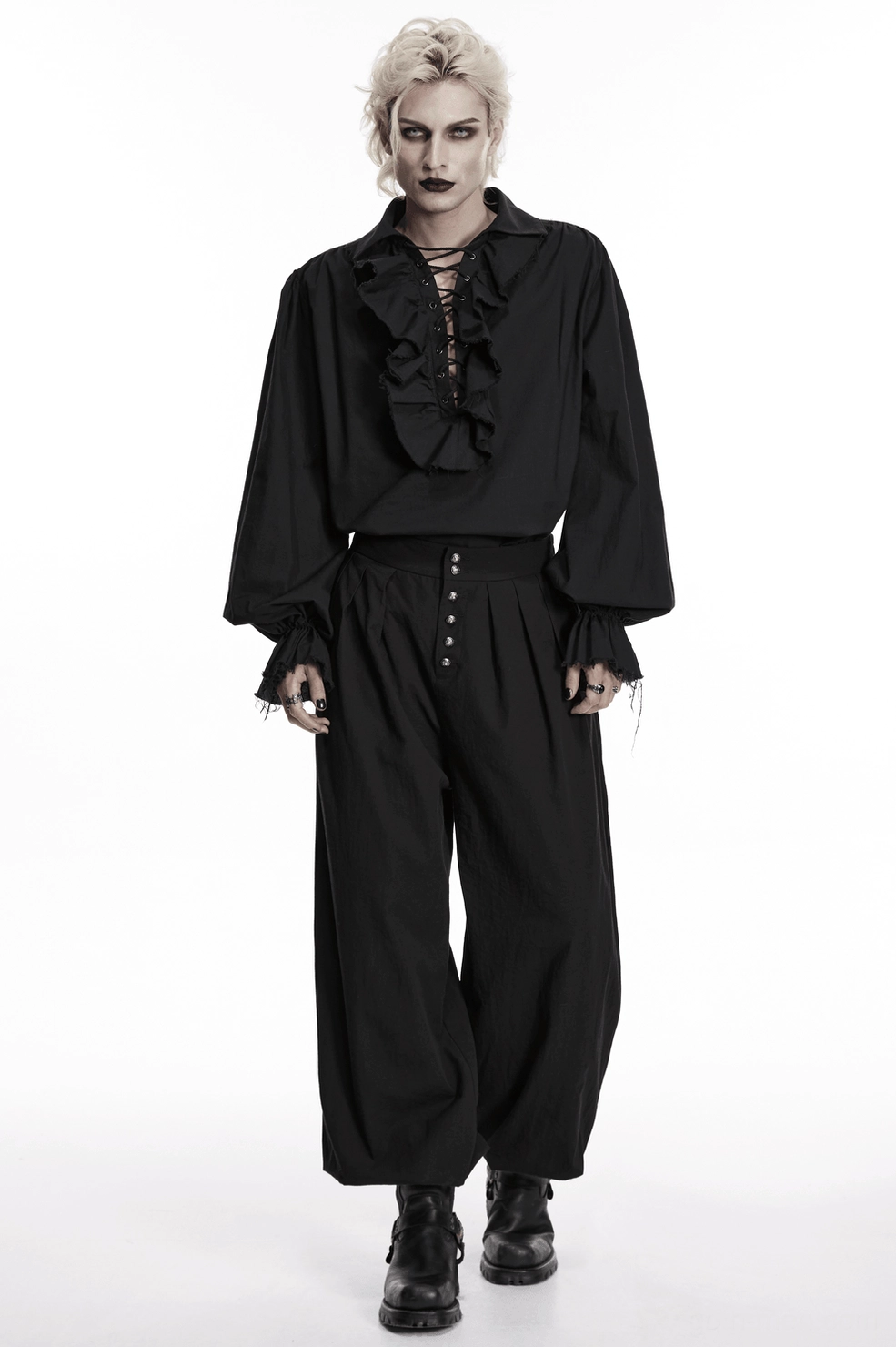 Black gothic pleated tapered pants front studio view, highlighting metal button detail and structured waistline pleating