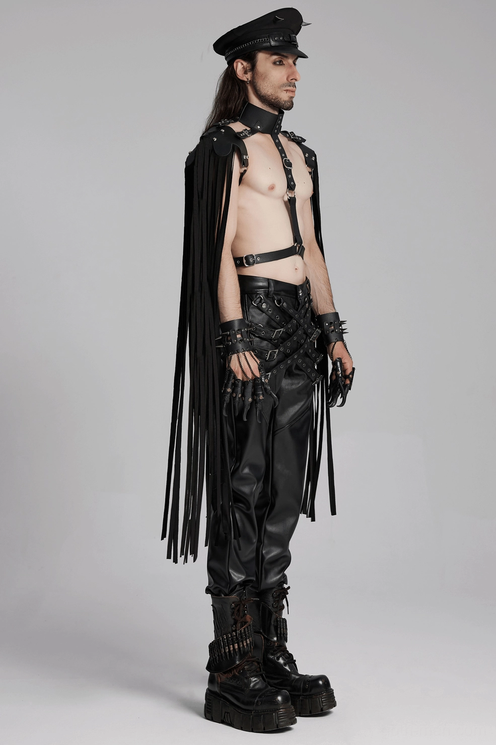 Detail shot of black gothic leather pants leg hem and buckle loop construction