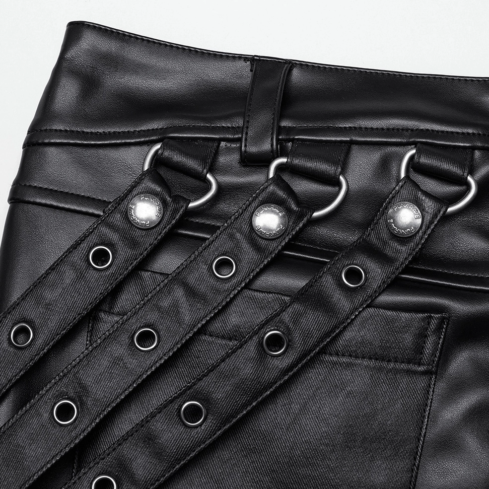 Close-up detail of black gothic pants waist showing metal eyelets and round metal buttons