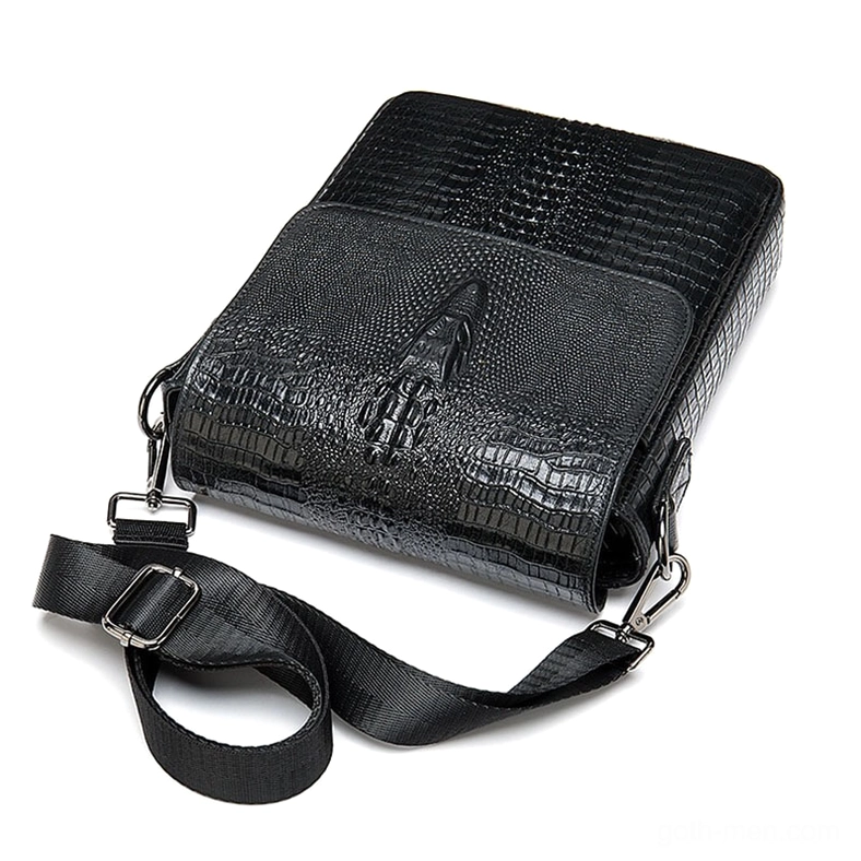 Black crocodile leather shoulder bag oblique view - detachable nylon strap and metal hardware details on gothic messenger design