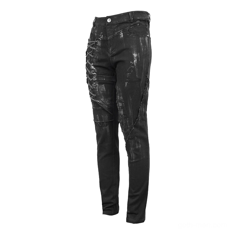 Right rear angled view of black gothic trousers highlighting paint splatter finish and strap detail