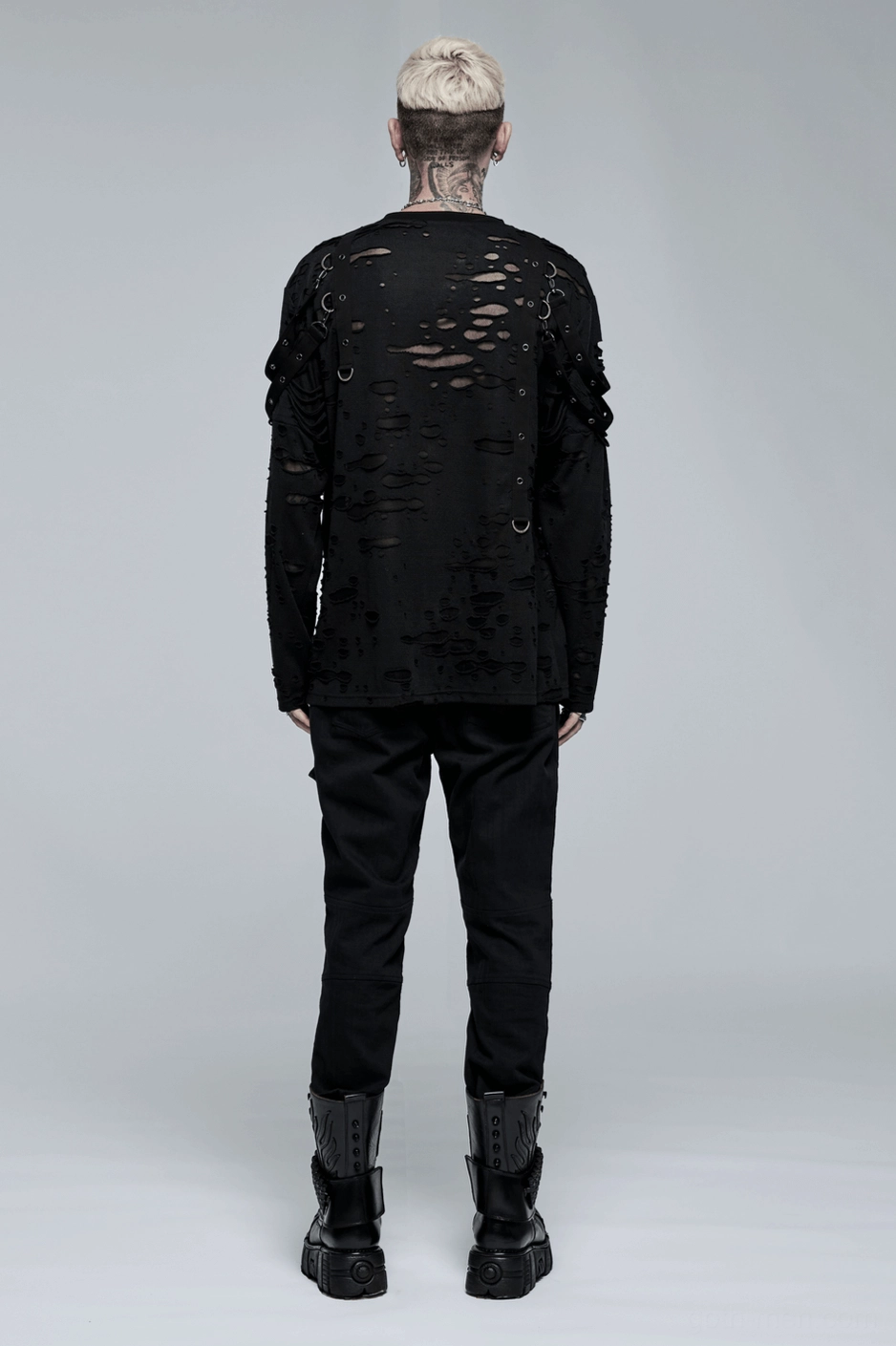 Standing model view of black gothic punk cargo pants with skull-button waist closure and industrial hardware