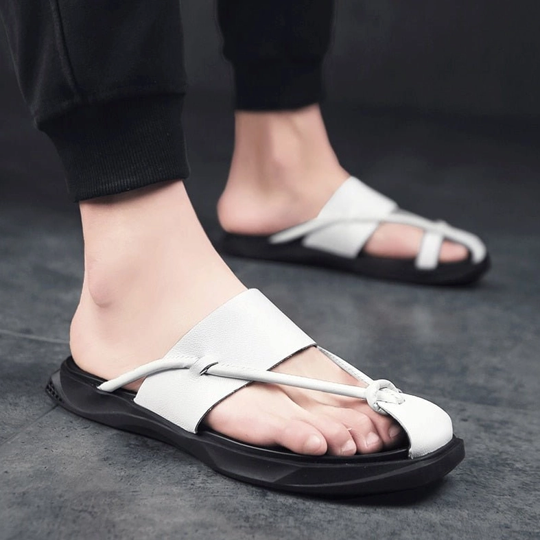 Side view of black gothic ankle-wrap sandals showing ergonomic support structure and leather texture