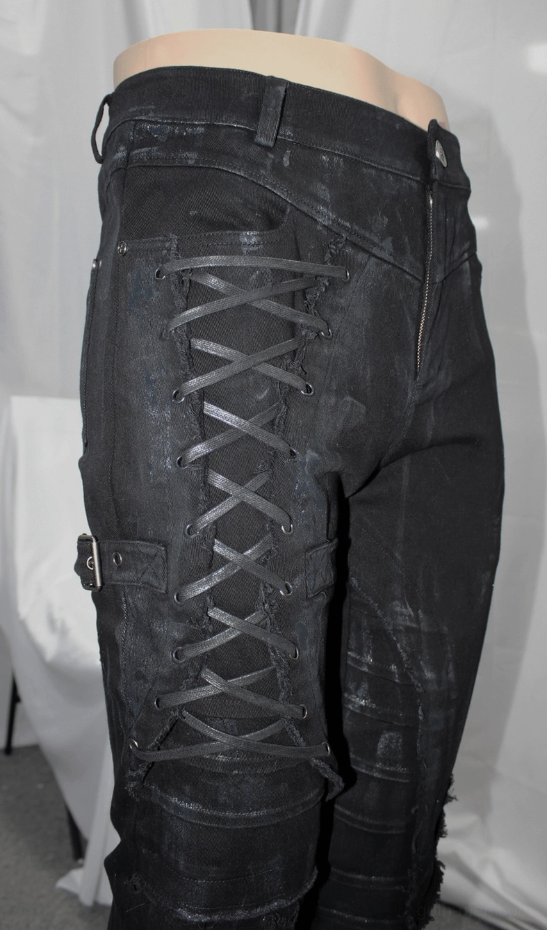 Full-body studio shot of male model wearing black gothic slim-fit lace-up pants in alternative style