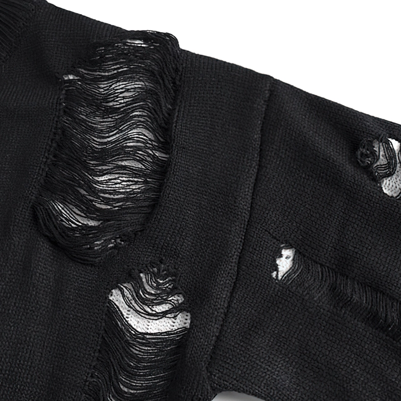Distressed black knit fabric detail showing frayed cutouts and exposed white inner layer - texture close-up
