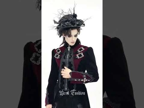 Male model wearing black gothic tailcoat with cross zipper and ornate lace detailing, 3/4 view with gothic headdress accent