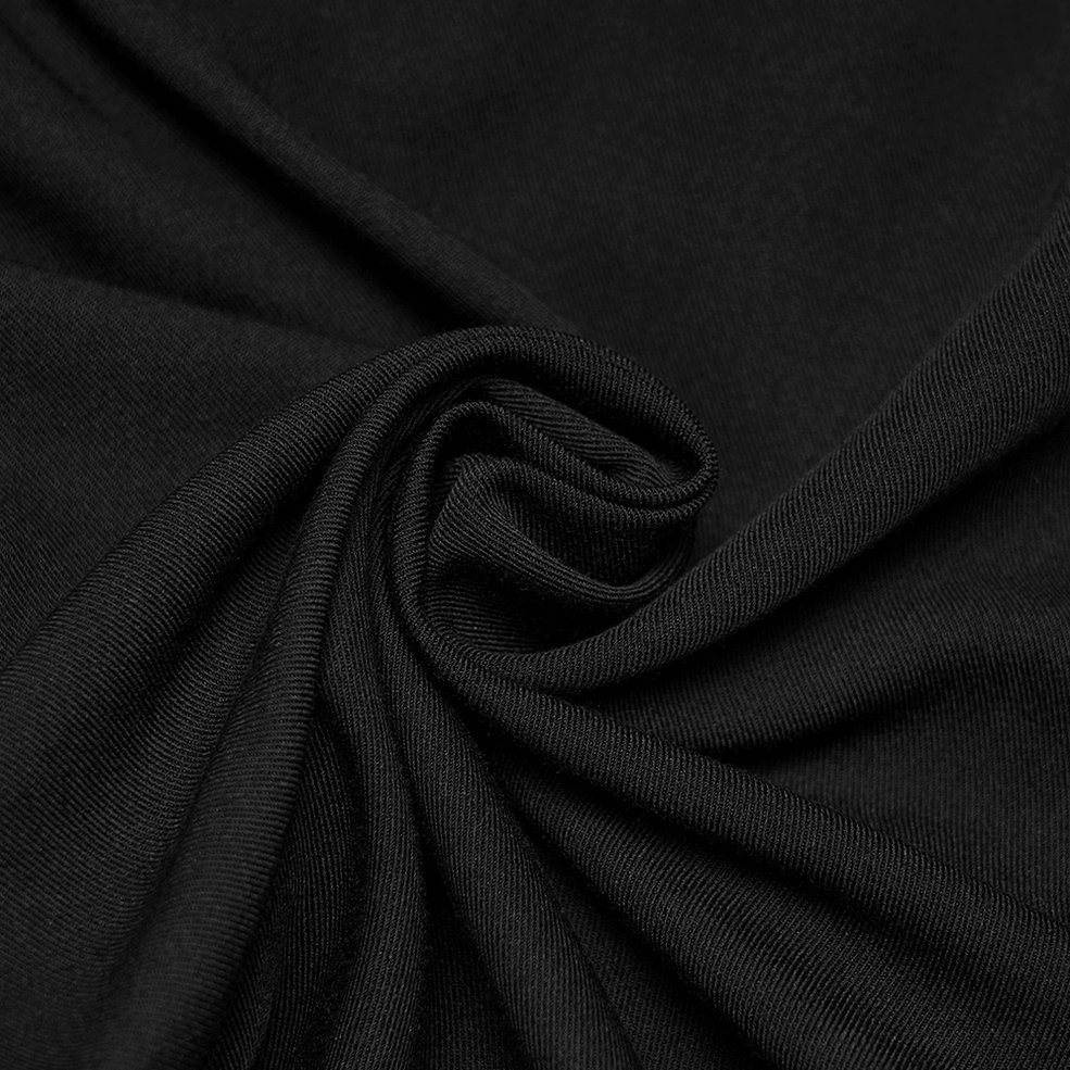 Full-length side view of black gothic embroidered trousers on male model showing fit and drape