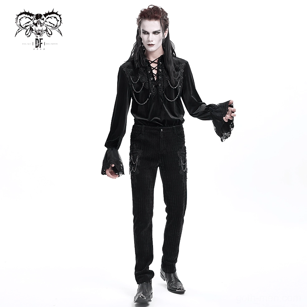 Black gothic velvet pants with chain and embroidered cross details - front three-quarter angle
