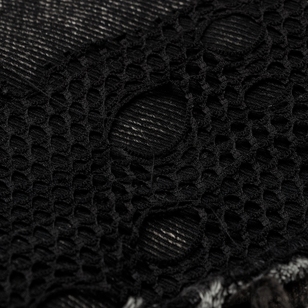 Black gothic denim vest showing embroidered patch design and mesh panel construction detail