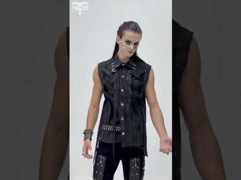 Black gothic sleeveless shirt partial front view on male model with metal accessories and studded belt