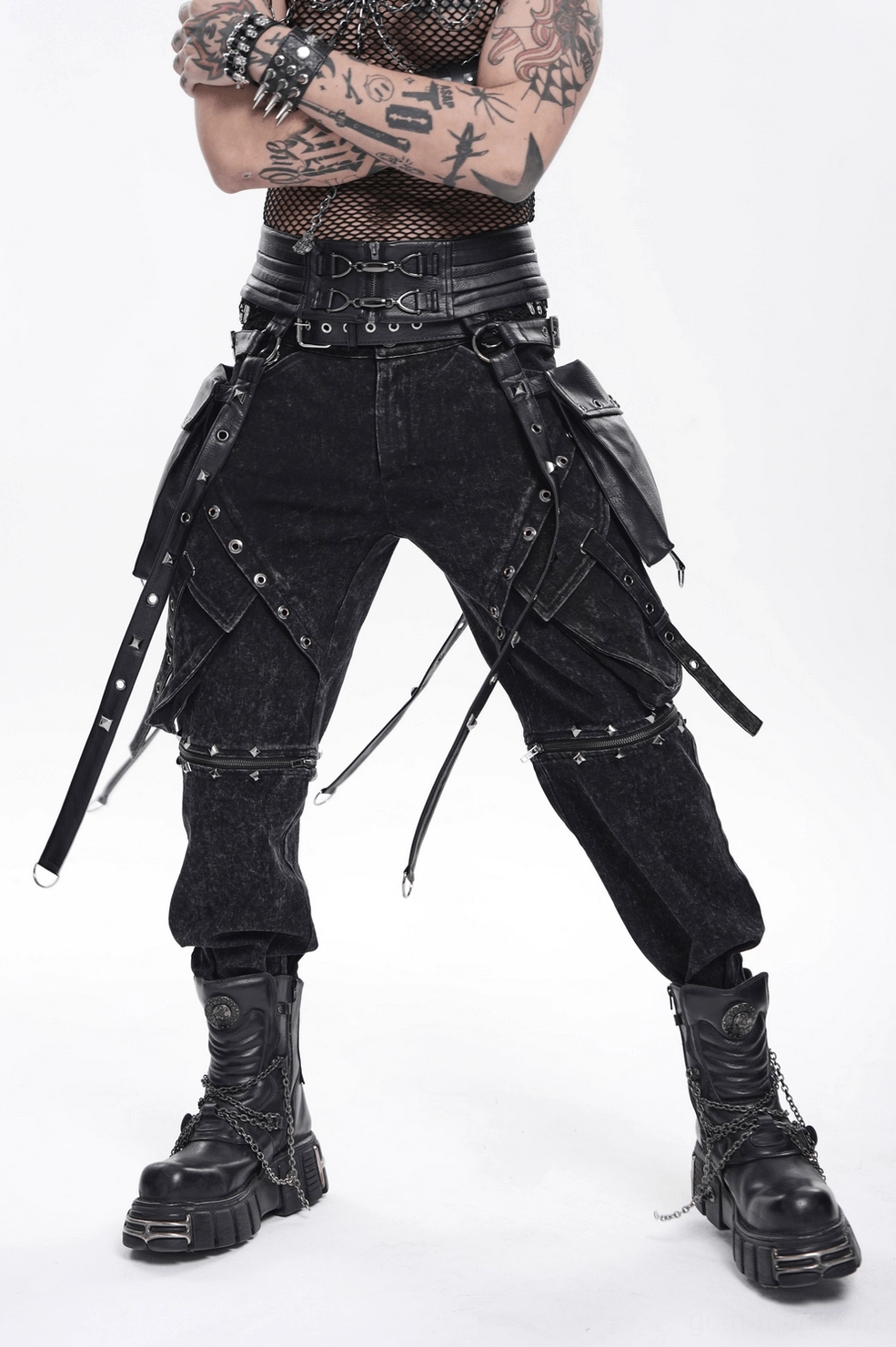 Black leather harness body piece showing double buckle closures and metal rivet details on white display mannequin