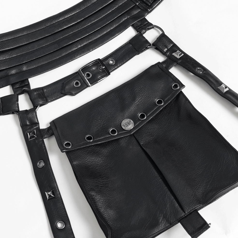 Black faux leather utility harness flat lay on dark background, showing full strap system and overall design architecture