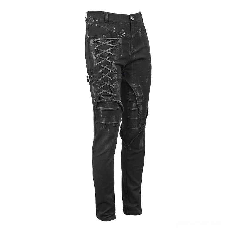 Left front angled view of black slim-fit gothic pants with distressed paint detail and lace-up fastening