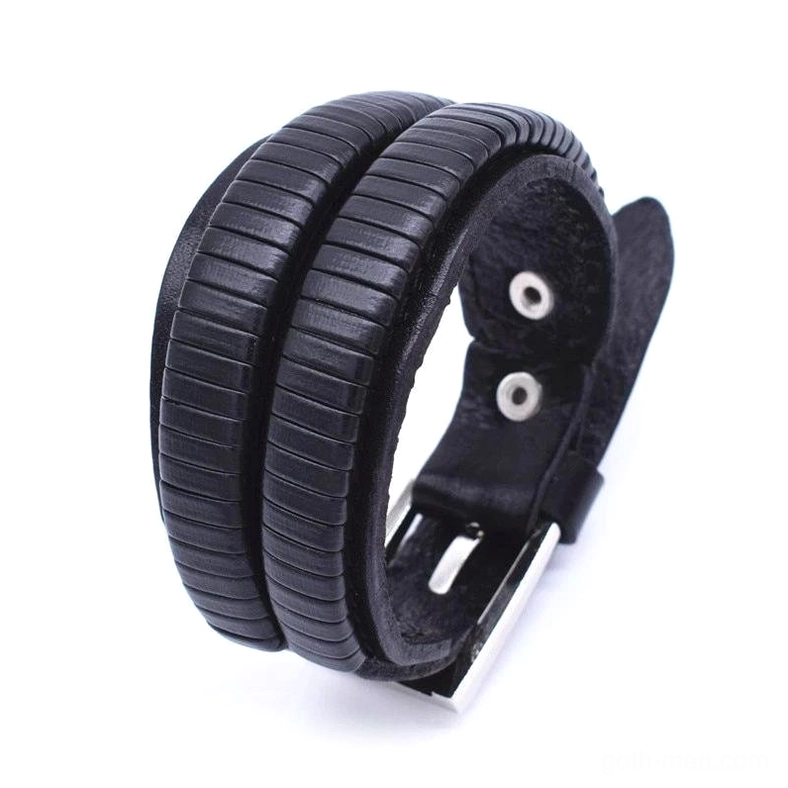 Black leather cuff bracelet back side view showing striped embossed texture, metal adjustment components, gothic men's jewelry