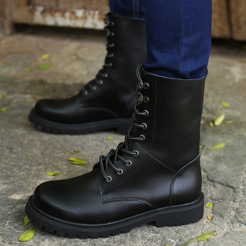 Black matte leather combat boots showing double side view with metal lace hardware and structural boot details