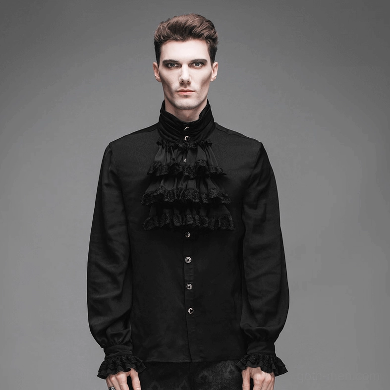 Male model wearing black Gothic ruffled jabot shirt with front button closure and decorative cuffs in grey studio setting