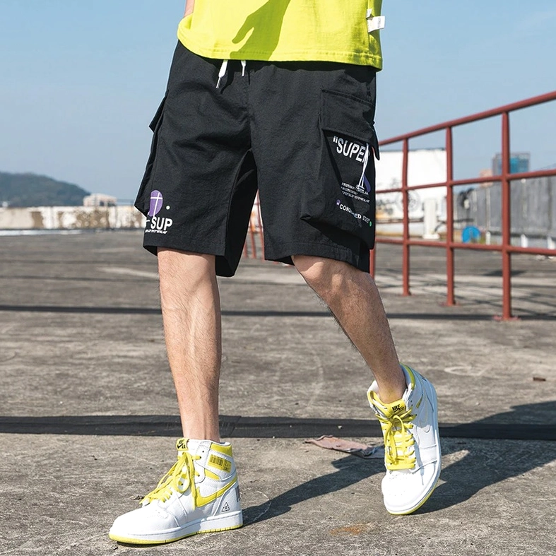 Close-up of black cargo shorts side pocket detail and stitching quality