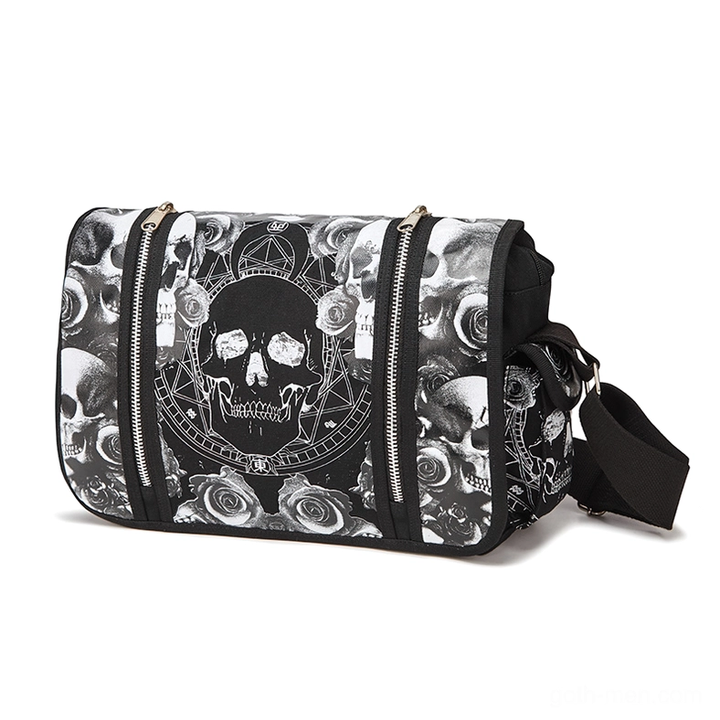 Black gothic skull canvas crossbody bag with dual zippers, front three-quarter view showing printed rose and skull pattern