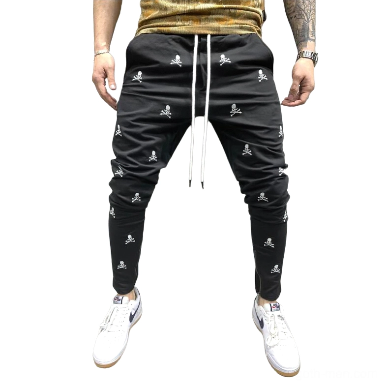 Black gothic skull lace-up pencil pants with drawstring waist, worn by male model showing front profile against studio background