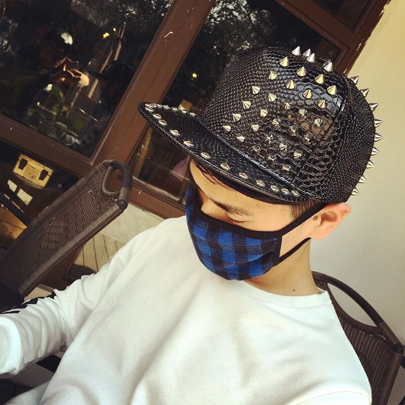 Alternative gothic studded cap worn by model, low side angle view showing wearable dark aesthetic
