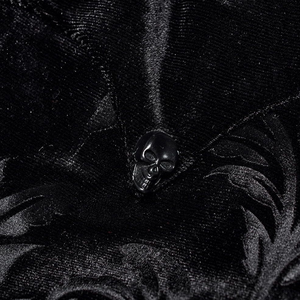 Macro close-up detail of black velvet gothic shirt front button with skull motif and soft premium velvet surface