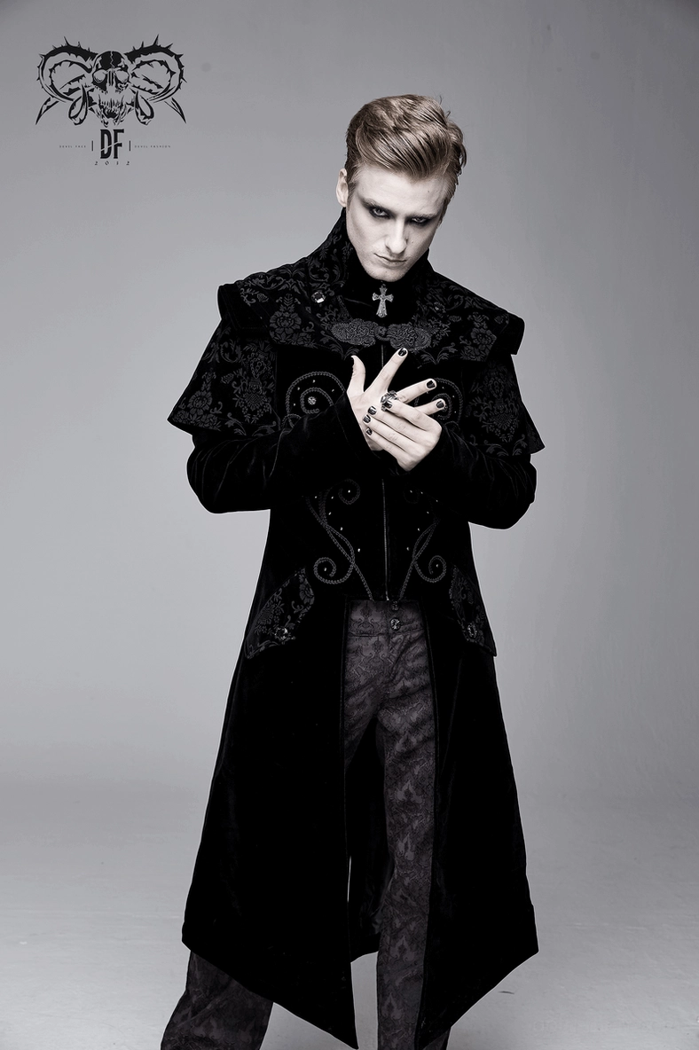Black velvet gothic coat worn on male model demonstrating how removable cross collar transforms garment appearance