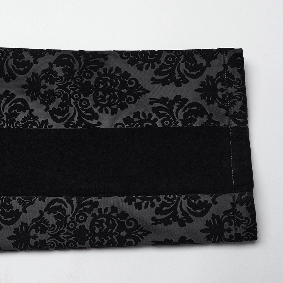 Black velvet gothic pants detail view showing damask flocking texture and refined tailoring on leg