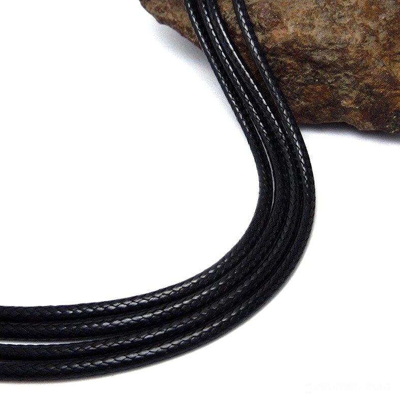Close-up detail of black braided wax cord texture showing woven strands and multiple coils of gothic necklace