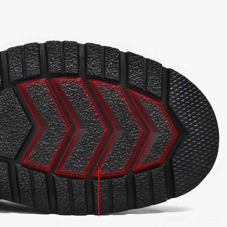 Close-up of black boot outsole showing chevron anti-slip pattern and rubber material