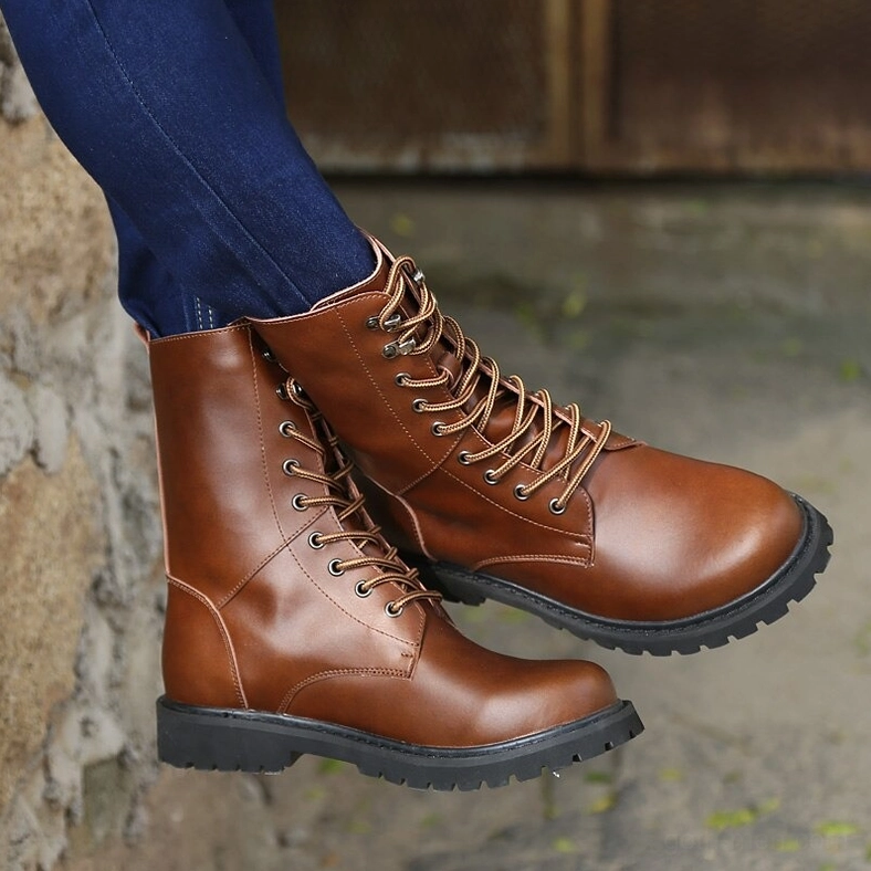 Brown high-top combat boots with thick rubber sole on outdoor stone wall surface, showcasing clean leather texture and durability