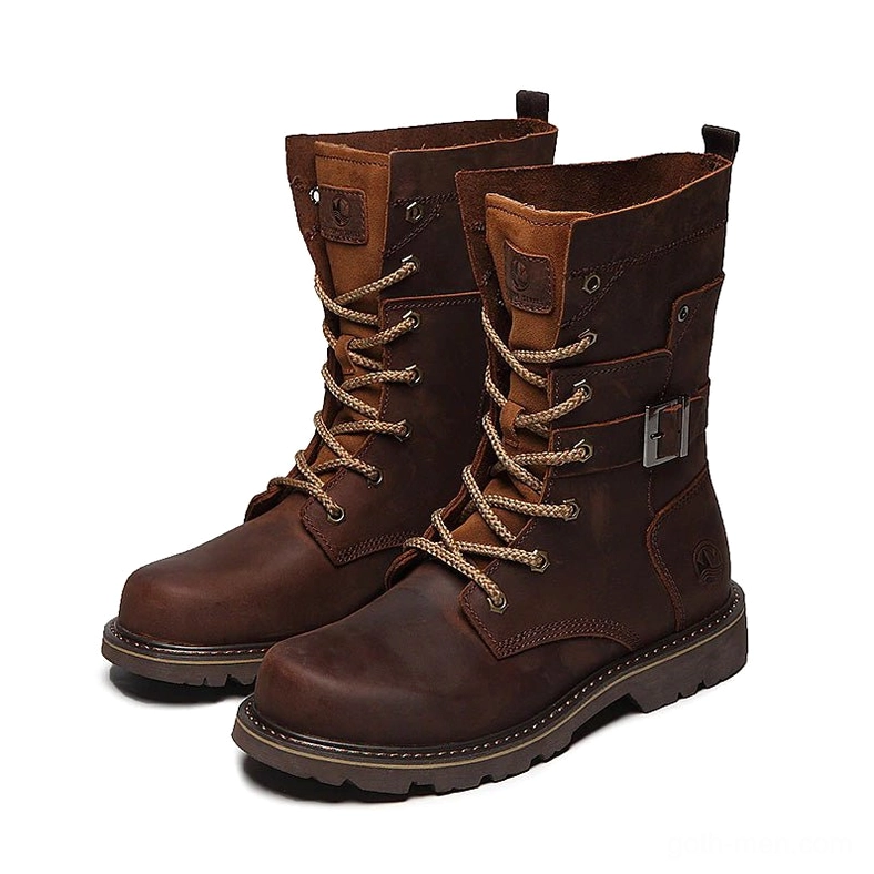 Pair of brown distressed leather combat boots with thick lug sole, front-side studio view