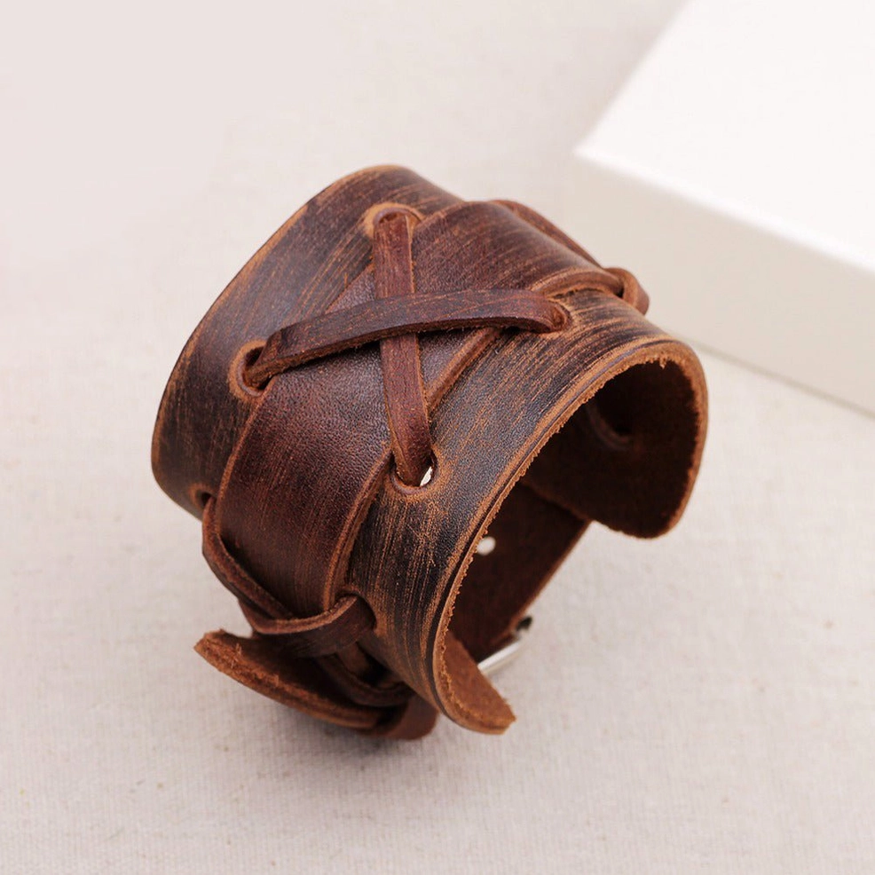 Side oblique view of vintage brown leather gothic bracelet showing cross-lace texture and aged leather distressing details