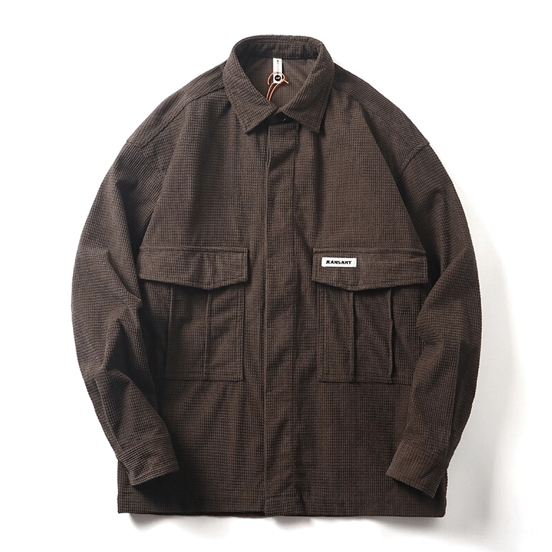 Dark brown waffle cord oversized gothic cargo shirt flat lay shot on white studio background, displaying structured dual pockets and cord fabric weave pattern