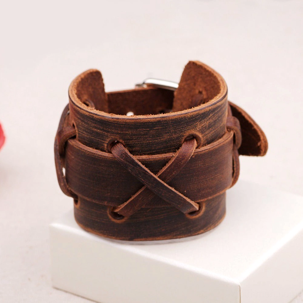 Vintage brown genuine leather gothic wristband with double-layer cross-lace design and metal buckle adjustment on white display stand